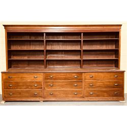 Large mahogany haberdashery cabinet shop fitting, early 20th century and later, the top section fitted with nine shelves, above nine deep drawers sliding out on rollers, on a skirted base. Disassembles for transport. H237cm, L373cm, D95cm.  - COLLECTION BY APPOINTMENT FROM: The White House, Thirsk Road, Easingwold, York, YO61 3NF - CALL 01723 507111 TO ARRANGE