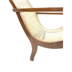 Walnut framed plantation type armchair, shaped cresting rail over cane work seat and back, with matching cane work stool,  H101cm, D115cm, 81cm, stool H32cm
