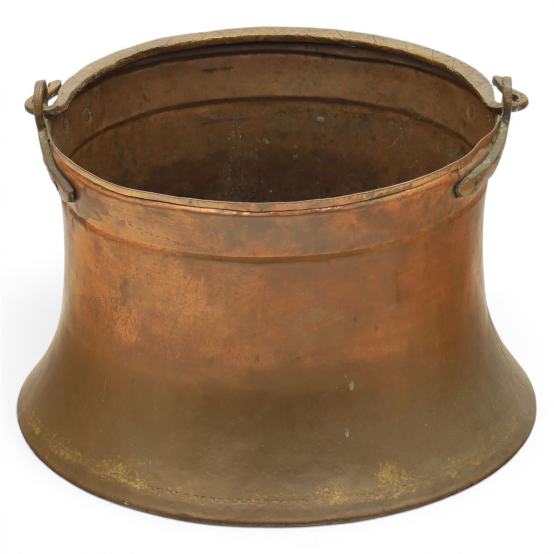 19th century brass and copper cauldron, circular open body with rolled rim, riveted side mounts and swing carrying handle, on broad flared circular foot