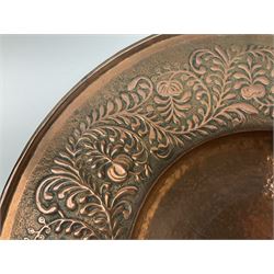 Arts and Crafts Keswick School of Industrial Arts copper charger, decorated with planished centre and repousse scrolling foliate tendrils to rim, D44cm