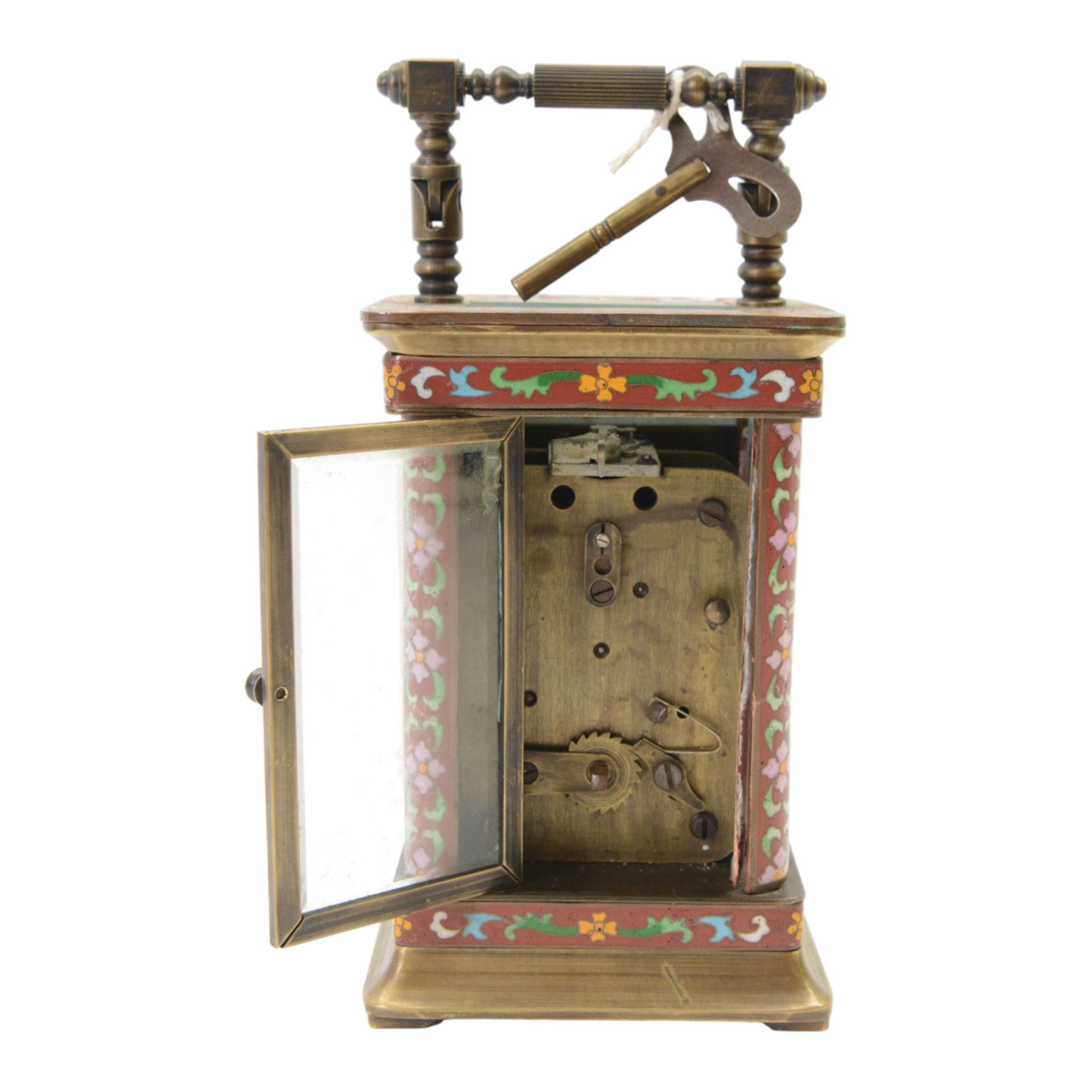 Late 20th century- Chinese 8-day timepiece carriage clock with Cloisonne work on a red ground to the four pillars, base and cornice, with painted porcelain panels to the sides, white enamel dial with Roman numerals and trefoil steel hands, platform escapement wound and set from the rear. With Key.