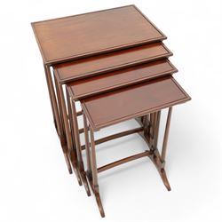 Early 20th century mahogany quartetto nest of four occasional tables, each with rectangular top with raised lip moulding, turned supports on splayed feet