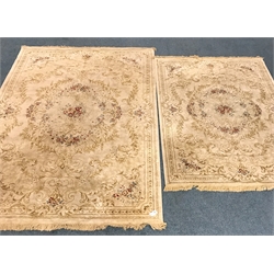  Pair graduating Persian style gold ground rugs central medallion, repeating border, 293cm x 193cm and 227cm x 155cm mao0207  