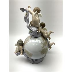 A Lladro mantel clock modelled as a globe with inset clock, surmounted by four putti and floral garlands, with blue printed mark and impressed 5973 beneath, H29cm.