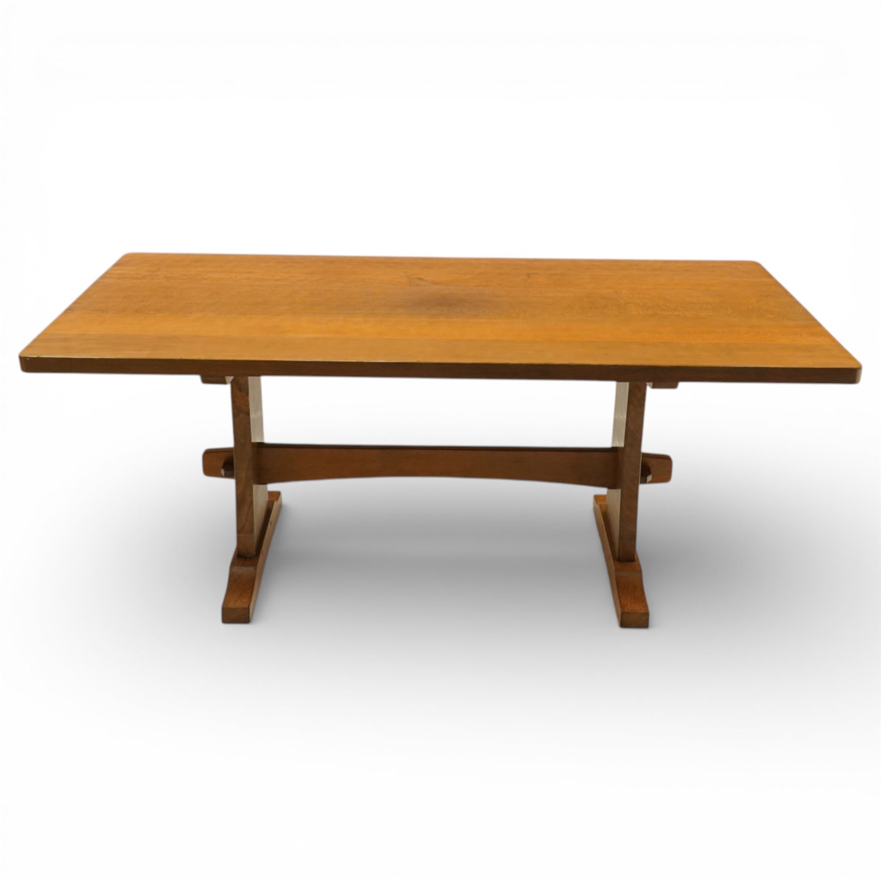 Beaverman - oak adzed top refectory table, the rectangular top raised on twin trestle supports with shaped feet united by a stretcher, the joints secured with exposed pegs, with carved beaver signature, by Colin Almack of Sutton near Thirsk