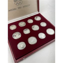 Russian 1980 Moscow Olympic Games silver twenty eight coin set, housed in dated red case and four other coins relating to the Olympics, housed in dated black case