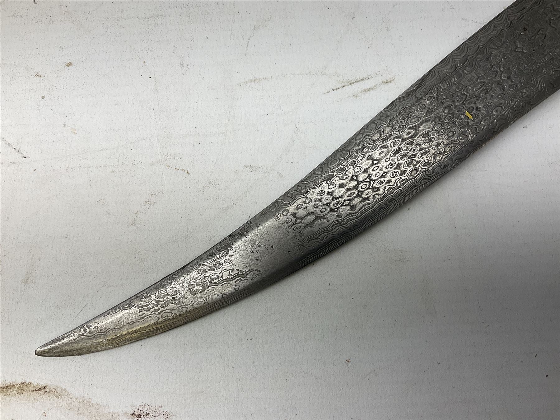 Indian Khanjar dagger with 28cm curving damascus steel blade inlaid with silver floral emblem, white metal and niello style grip in the form of a bird's head with pronounced beak and matching scabbard L44cm overall