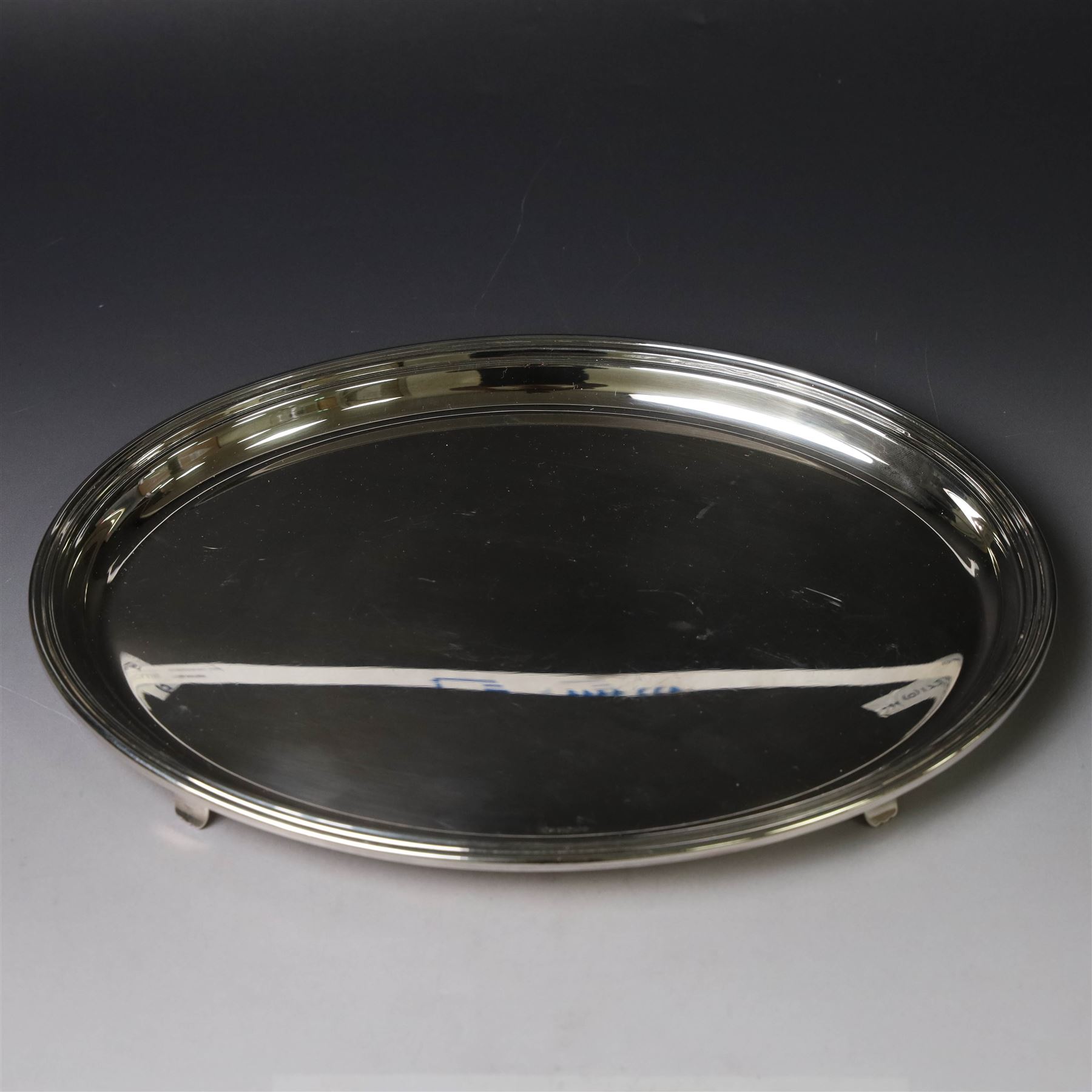 Modern silver tray, of oval form with stepped rim and upon four pad feet, hallmarked Victorian Silverware Ltd, Birmingham 2000, W28.5cm