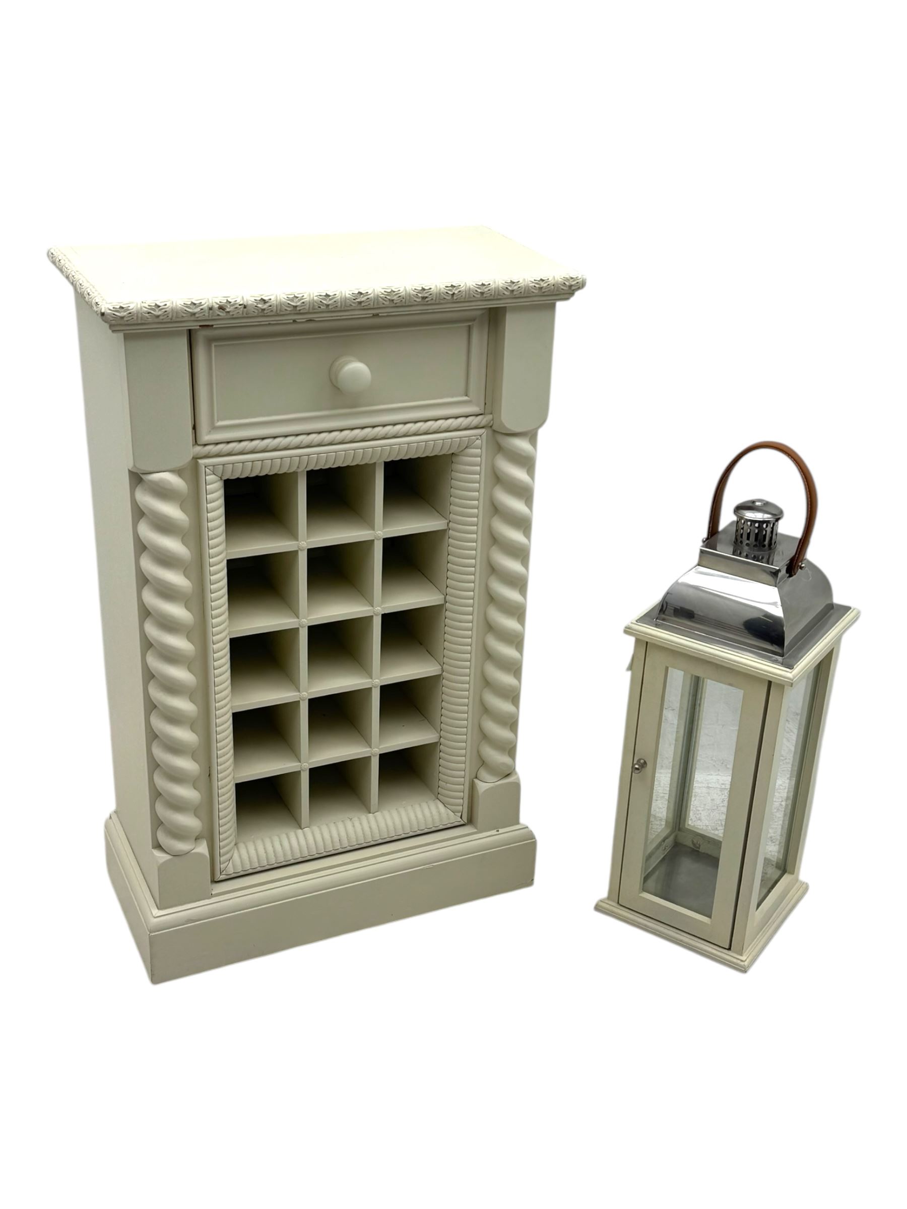 Contemporary painted wooden wine cabinet, rectangular form with carved leaf moulded cornice over single drawer and fifteen bottle compartments, flanked by spiral twist pilasters; together with a cream painted and chrome lantern, with glazed sides and leather handle (2)