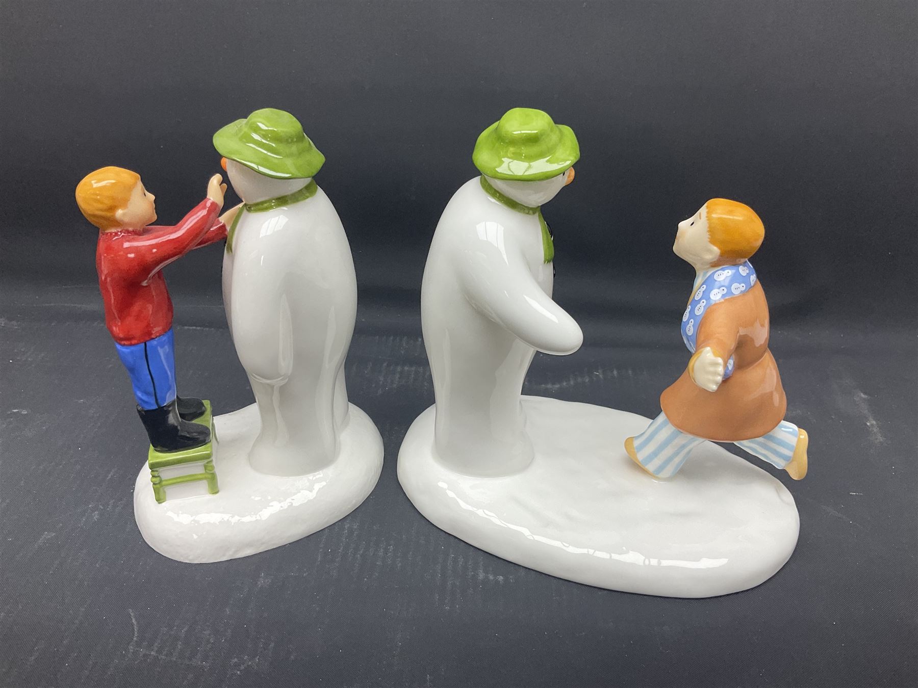 Four Coalport Characters The Snowman figures, comprising I'll Never Forget you with certificate, Pulling a Cracker and Adding a Smile, all with original boxes