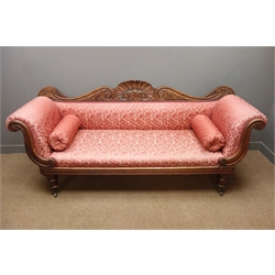  Victorian mahogany framed settee, shaped cresting rail with shell carving, scroll ends, upholstered in red floral fabric, turned supports, W225cm  