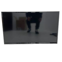 Panasonic 32 inch TV with DVD player and wall bracket and CD rack including various CDs 