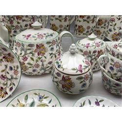 Minton Haddon Hall pattern tea and dinner wares, including basket dish, two covered tureens, six dinner plates, eight dessert plates, twelve tea plates, six soup bowls, six cereal bowls, teapot, coffee pot, milk jug, covered sucrier twelve tea cups and saucers, six mugs, footed bon bon dish, pair of candlestick holders, cake knife and slice etc (81)