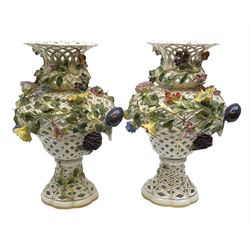 Pair of Meissen style pierced baluster vases, applied overall with fruit and flowering stems, possibly Samson, underglaze blue marks beneath, H33cm