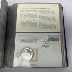Thirty-one 'International Society of Postmasters Official Commemorative Issues' sterling silver proof medallic covers dating from 1975 to1977, housed in the official folder and a 'Commemorating The Bicentennial Of The United States Of America' sterling silver proof medallic first day cover in blue wallet