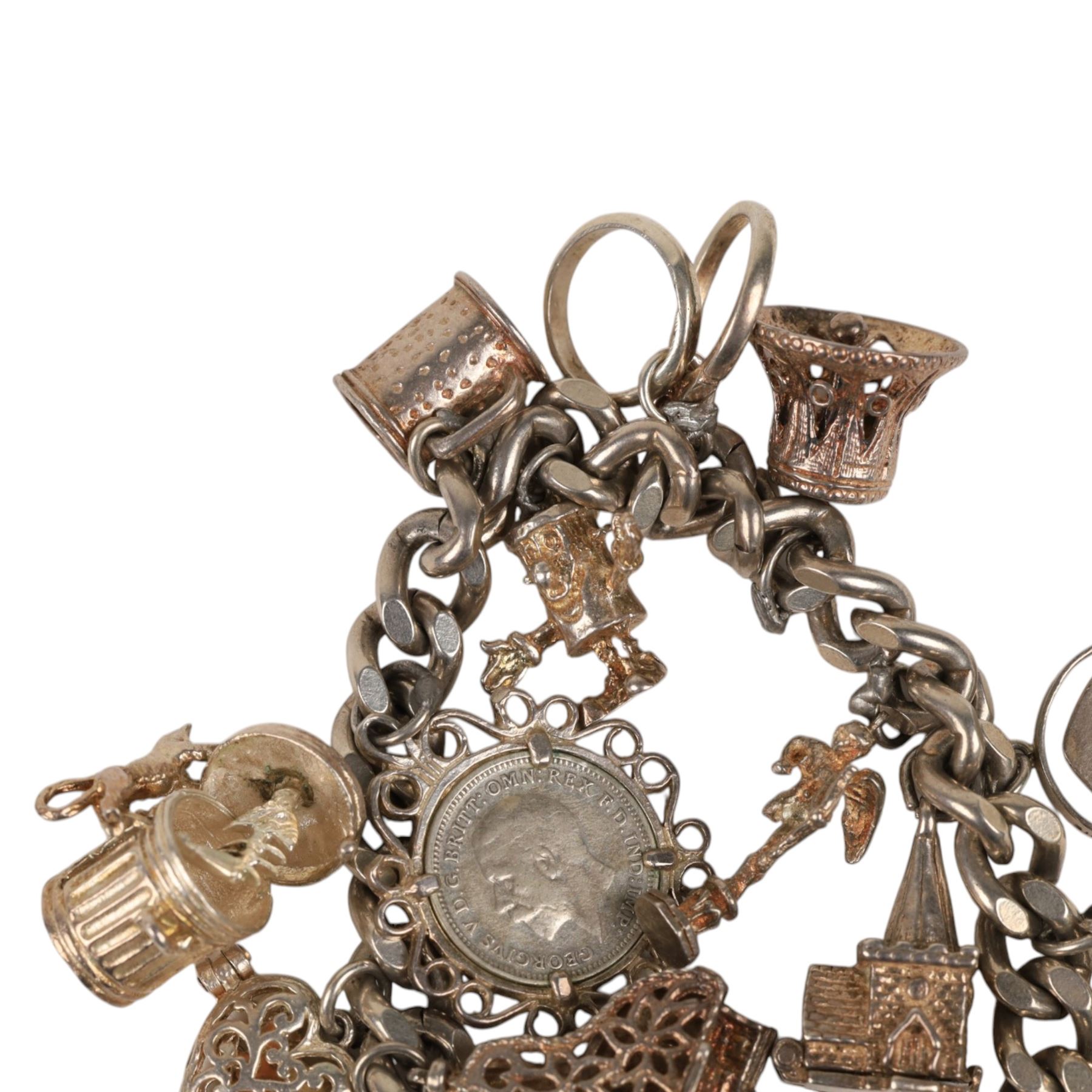 Silver charm bracelet, with seventeen charms including motorbike helmet, enamel toby jug, piano, etc