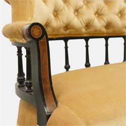 Late Victorian Aesthetic Movement settee, with buttoned upholstered roll-over back and arms, open spindle gallery frame with turned uprights, stuff-over seat, on shaped ebonised supports