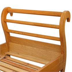 Unicornman - pair of craftsman-made oak single beds, of sleigh shape with scrolled head and foot-boards with octagonal stretchers, slatted base, raised on inward-splayed squared supports, applied with carved unicorn signature, by Geoff Gell of Coxwold