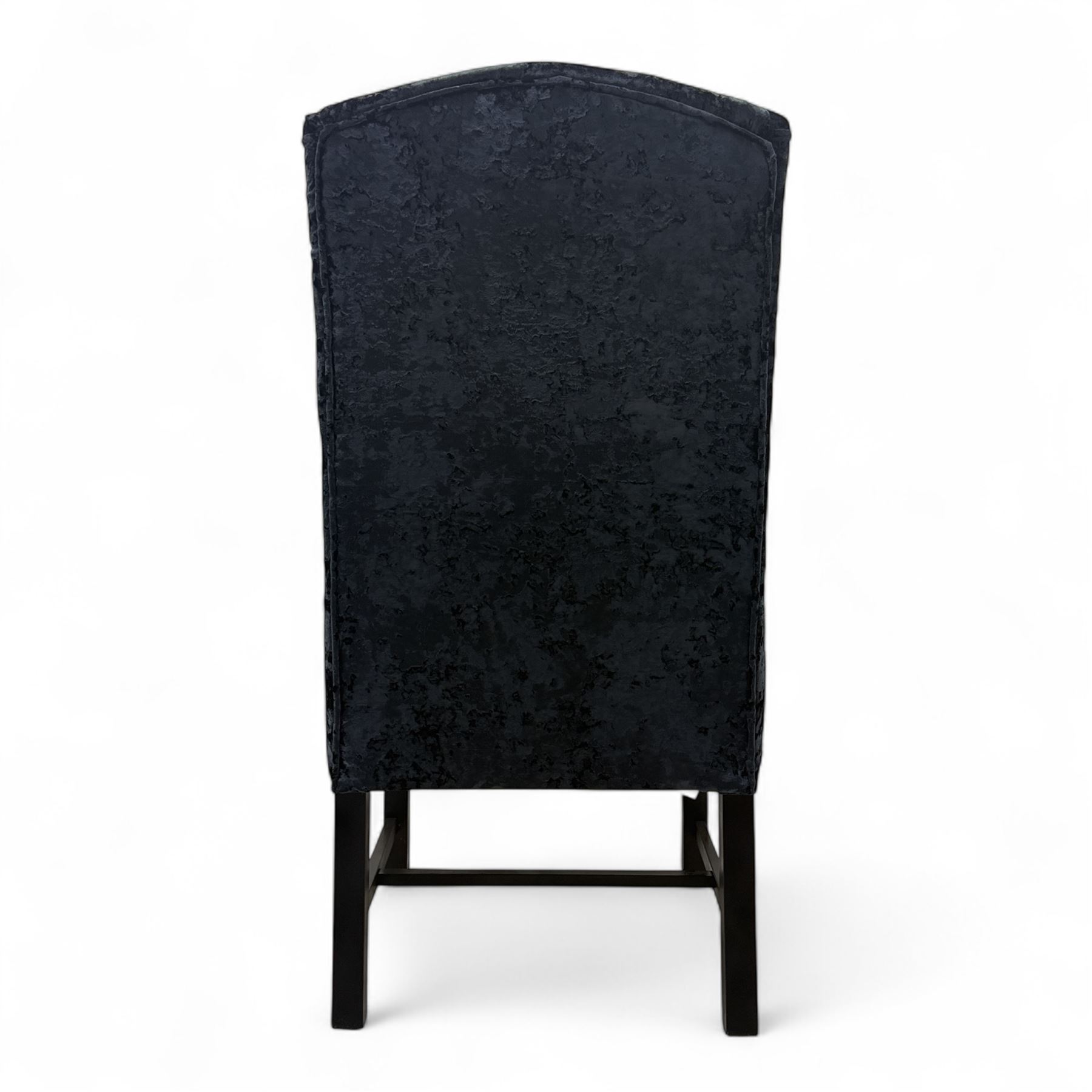 Oka - Pair of contemporary upholstered wingback armchairs, in black and blue textured velvet effect fabric, with tall scroll wing sides and square tapered legs joined by stretchers