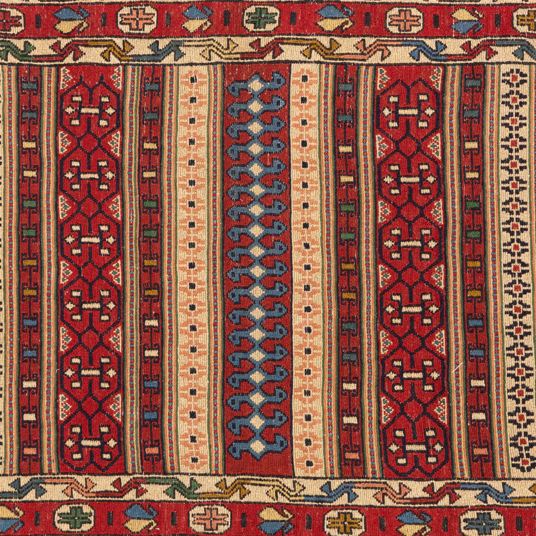North East Persian Sumak flatweave kilim runner, elongated field decorated with horizontal bands of stylized geometric motifs in madder red, ivory, indigo green, and ochre enclosed by bold geometric borders  