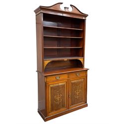 19th century inlaid mahogany bookcase on cupboard, swan neck pediment over three adjustable shelves, the base fitted with two drawers over two panelled cupboard doors, the facias inlaid with ornate urns surrounded by foliate