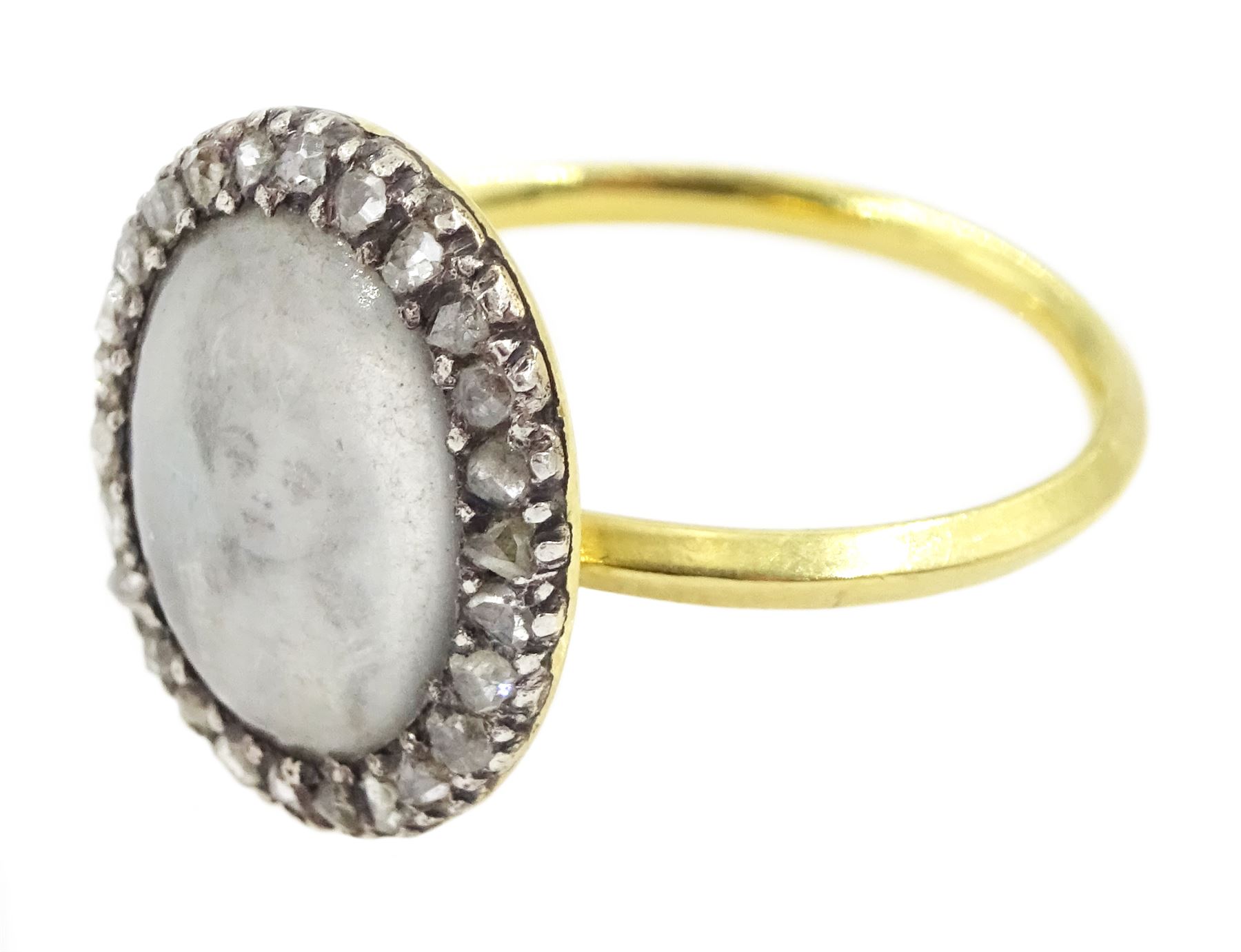18th / 19th century gold and silver diamond portrait ring, set with an oval miniature of a woman on ivory, under glazed panel, with rose cut diamond surround and angular shank. This lot has been registered for sale under Section 10 of the APHA Ivory Act