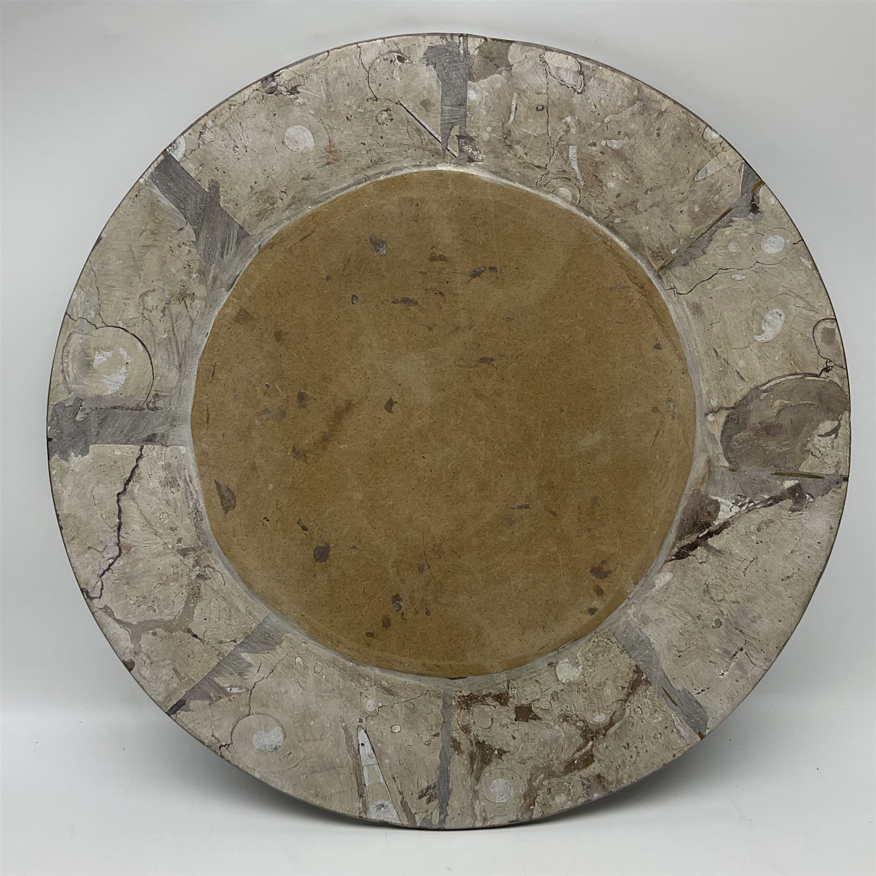 Circular limestone table top, with Orthoceras and Goniatite inclusions; age: Upper Devonian, location: Morocco, D45cm