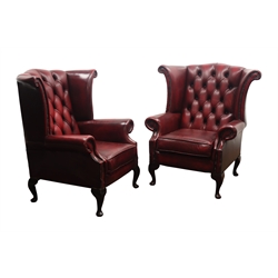  Pair George lll style wingback armchairs, upholstered in deep buttoned oxblood red leather, on cabriole legs, W90cm, H104cm, D75cm (2)  