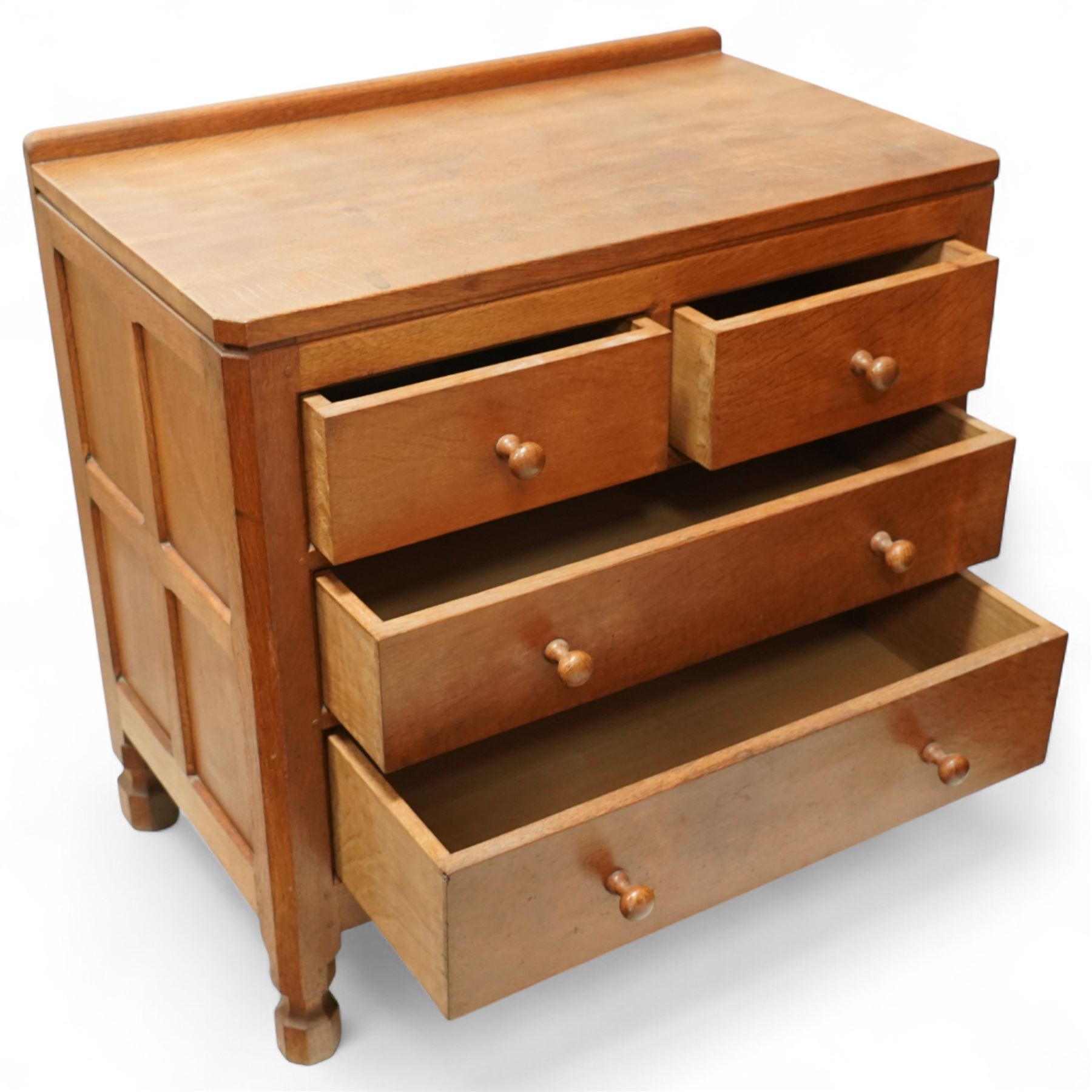 Mouseman - Oak chest of drawers, rectangular adzed top with raised gallery, two short over two long drawers with turned handles, raised on octangonal supports, carved mouse to the right edge, by the workshop of Robert Thompson, Kilburn.

Provenance - this lot comes to us for sale from direct descent of Robert Thompson. Thompson is the great grandfather of the vendor