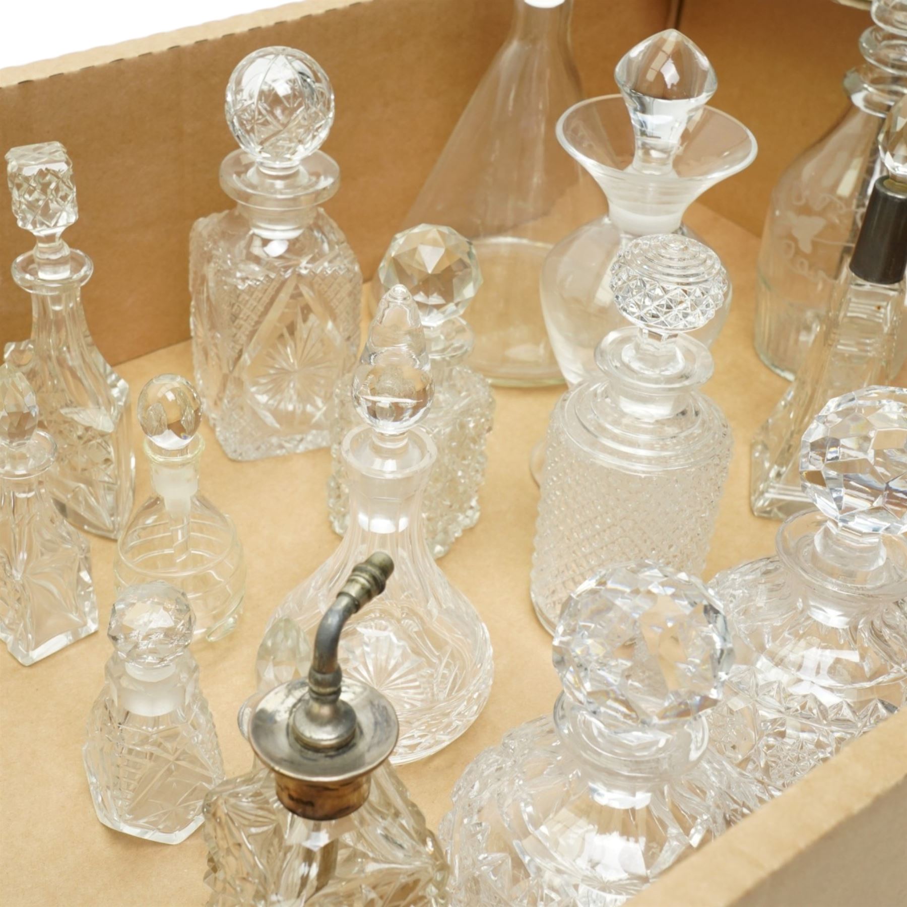 Glass atomiser with silver top, three glass scent flasks with silver collars, pair of cut glass globe scent flasks, other glass scent flasks and a 19th century etched glass liqueur decanter