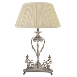 Silver plated Egyptian Revival lamp, with scrolling columns, on a trefoil base, surmounted...