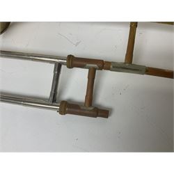 Three brass trombones comprising Elkhart Ind. USA 'CONN' model no.72H; Besson 'Concord'; and Selmer Distributed 'Lincoln'; two in carrying cases; and German B & M 'Champion' brass trumpet (4)