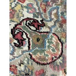 Persian design ivory ground rug, overall floral design with shaped central medallion, the main border decorated with trailing flower head pattern, within guard stipes 