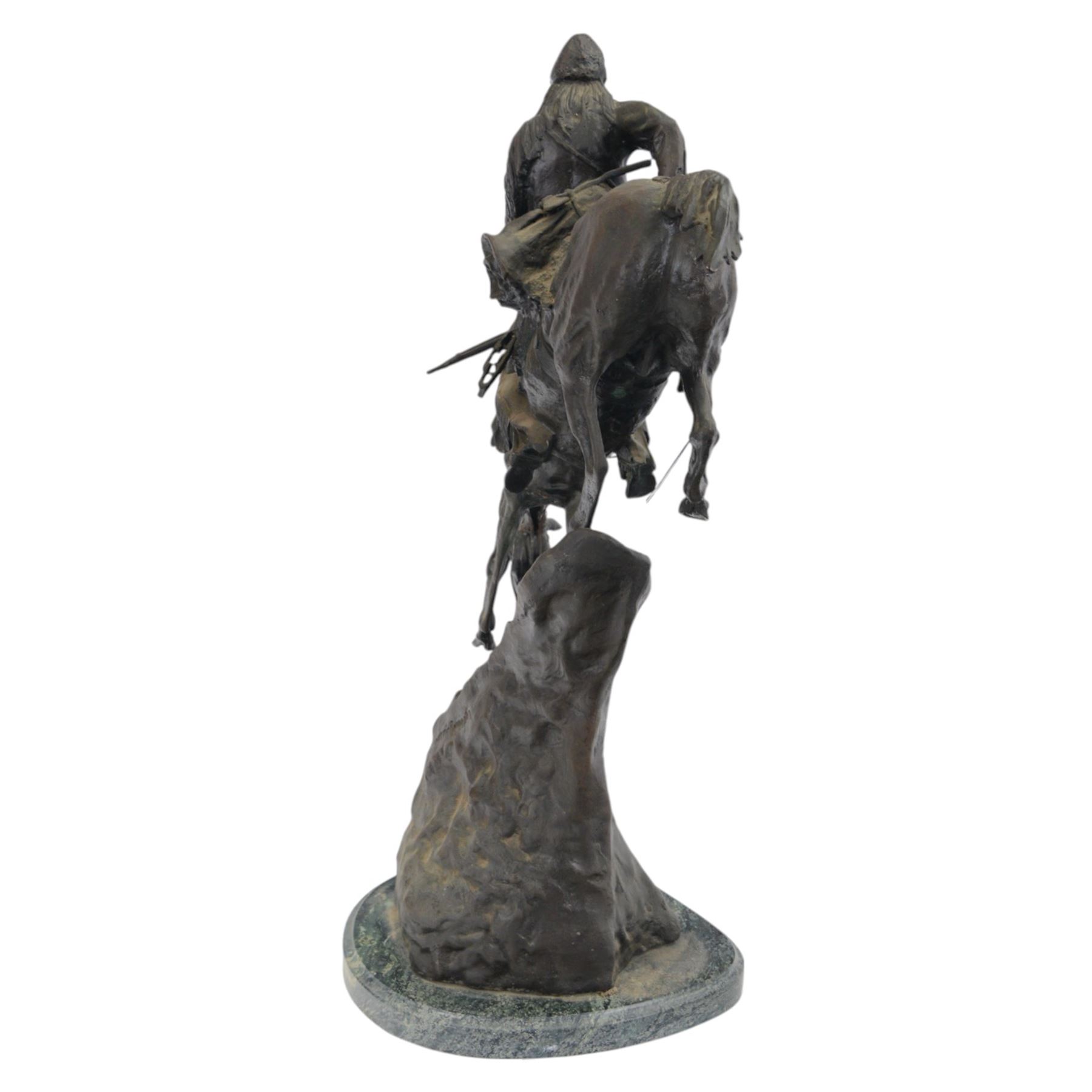 After Frederick Remington; The Mountain Man bronzed spelter figure of a native American trapper upon a marble base with plaque, H72cm