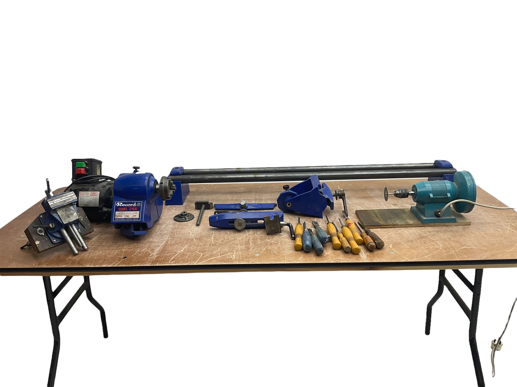 Record wood turning lathe and motor, with a three jaw chuck, tailstock and tool rest, selection of wood turning and woodworking chisels, electric bench grinder with grinding wheel and collet chuck plus a Record bench vice.