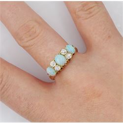 Early 20th century 18ct gold three stone opal, the centre stone set with two old cut diamonds either side, London 1913, total diamond weight approx 0.30 carat