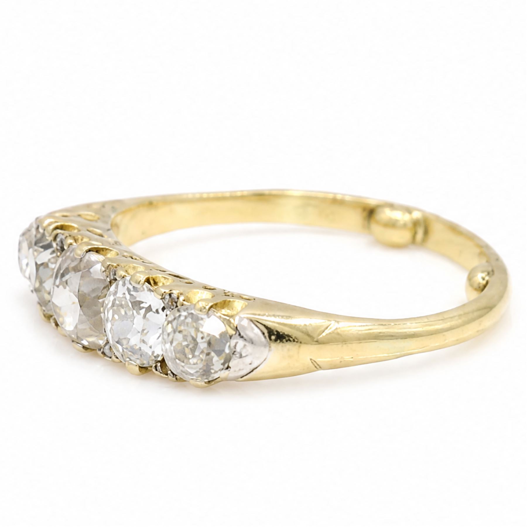 Early 20th century 18ct gold diamond ring, set with five graduating old cut diamonds and diamond accents, total diamond weight approx 1.55 carat