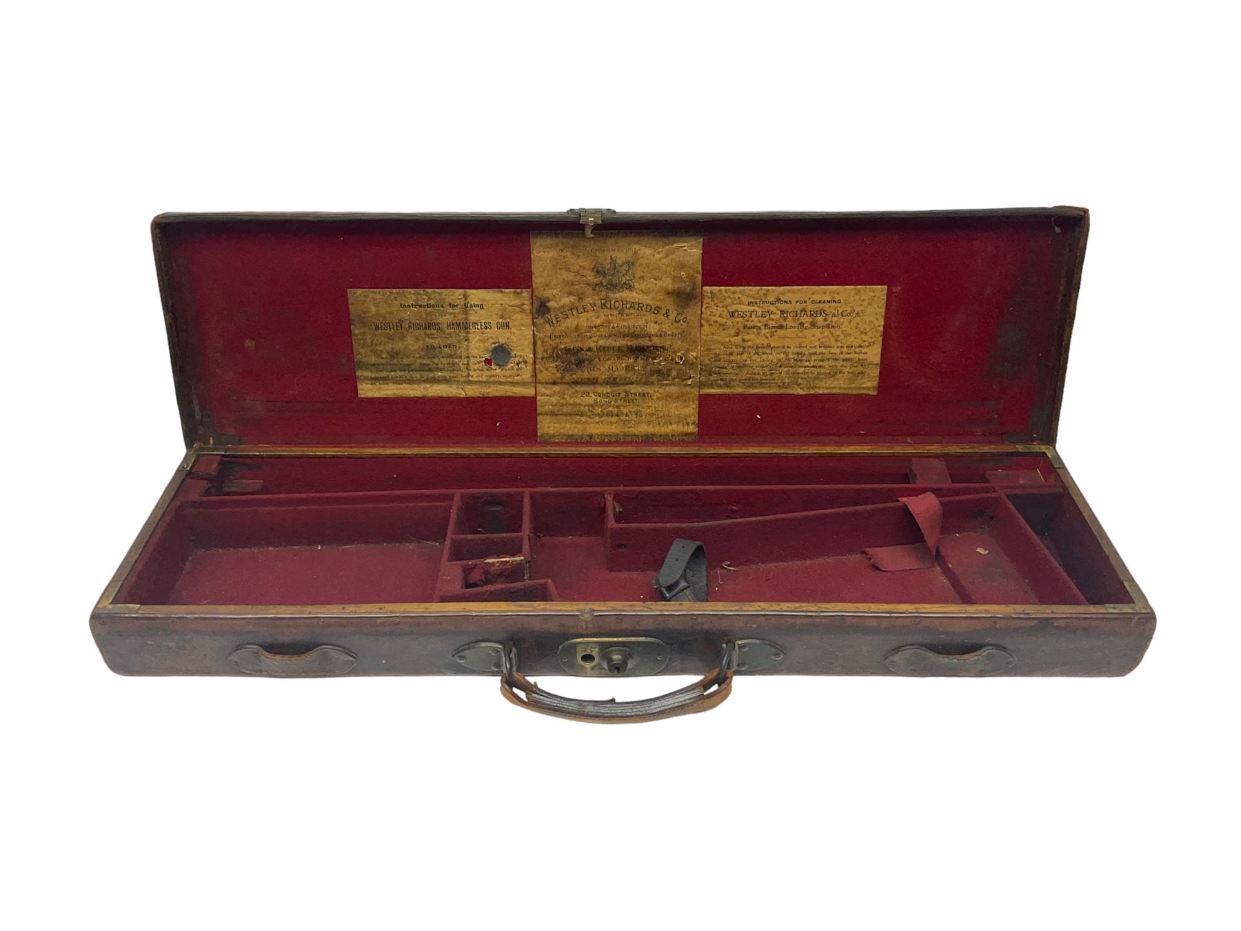 Leather shotgun case, the red baize lined interior with the trade labels of Westley Richards & Co., London, a brass plaque inscribed 'T Nevin, Mirfield, Yorkshire' to cover, with key, case to fit barrel 76cm (30 inches)  
