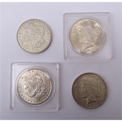  United States of America Morgan Dollars dated 1884 O mintmark and 1921 no mintmark and two Peace Dollars both dated 1922  