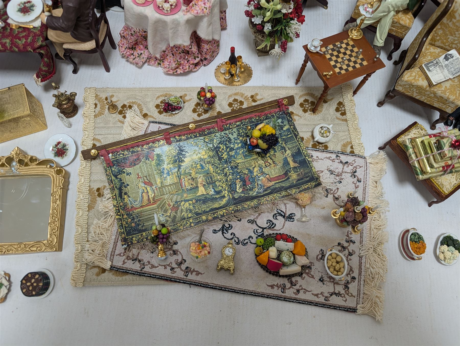 Dolls house living room and dining room furniture, including arm chairs, desk, fireplaces, dressers, tables, eight figures and a large collection of predominantly Christmas themed food, accessories and decorations