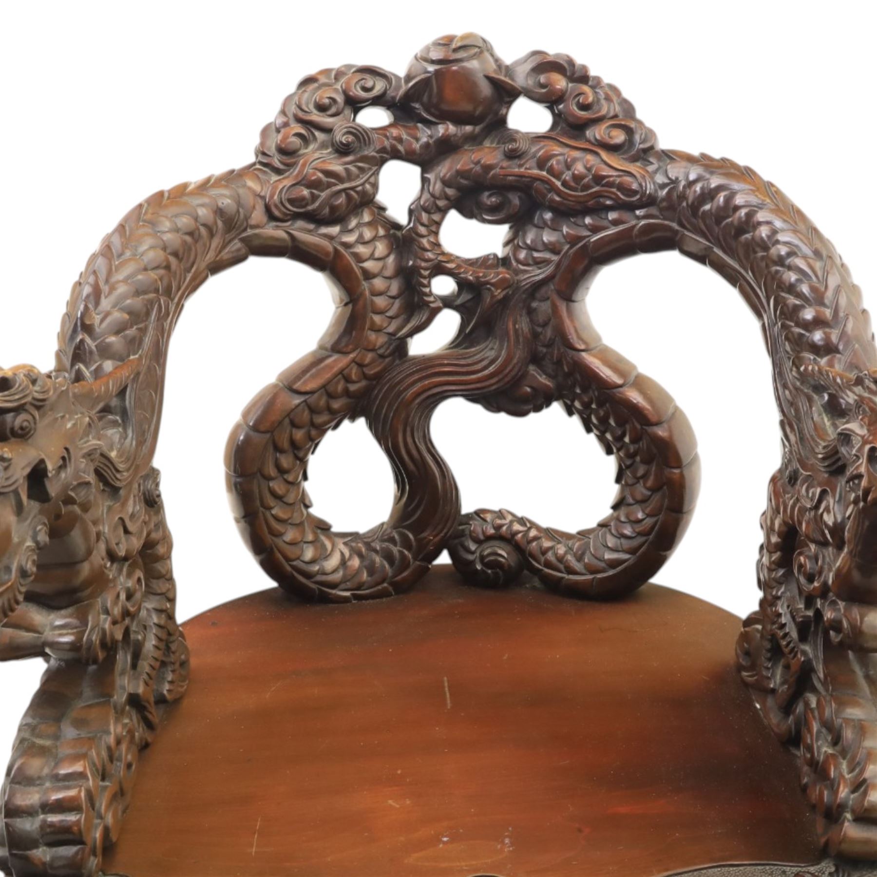 Chinese carved hardwood dragon throne chair, the shaped and pierced back with entwined dragons and cloud motifs, sweeping dragon-form arms terminating in carved heads, solid panel seat over foliate carved apron, on four mask carved cabriole supports