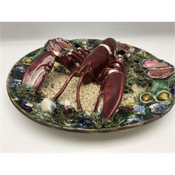 Two 20th Century Portuguese Palissy style Majolica wall plates, one depicting a crab, the other a lobster each to the centre modelled in relief surrounded by encrustations and shells, both with impress marks beneath, D34cm