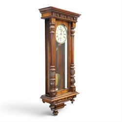 19th century mahogany Vienna Regulator wall clock, carved mahogany framed with turned and half-canted pilasters, over a lobed terminal
