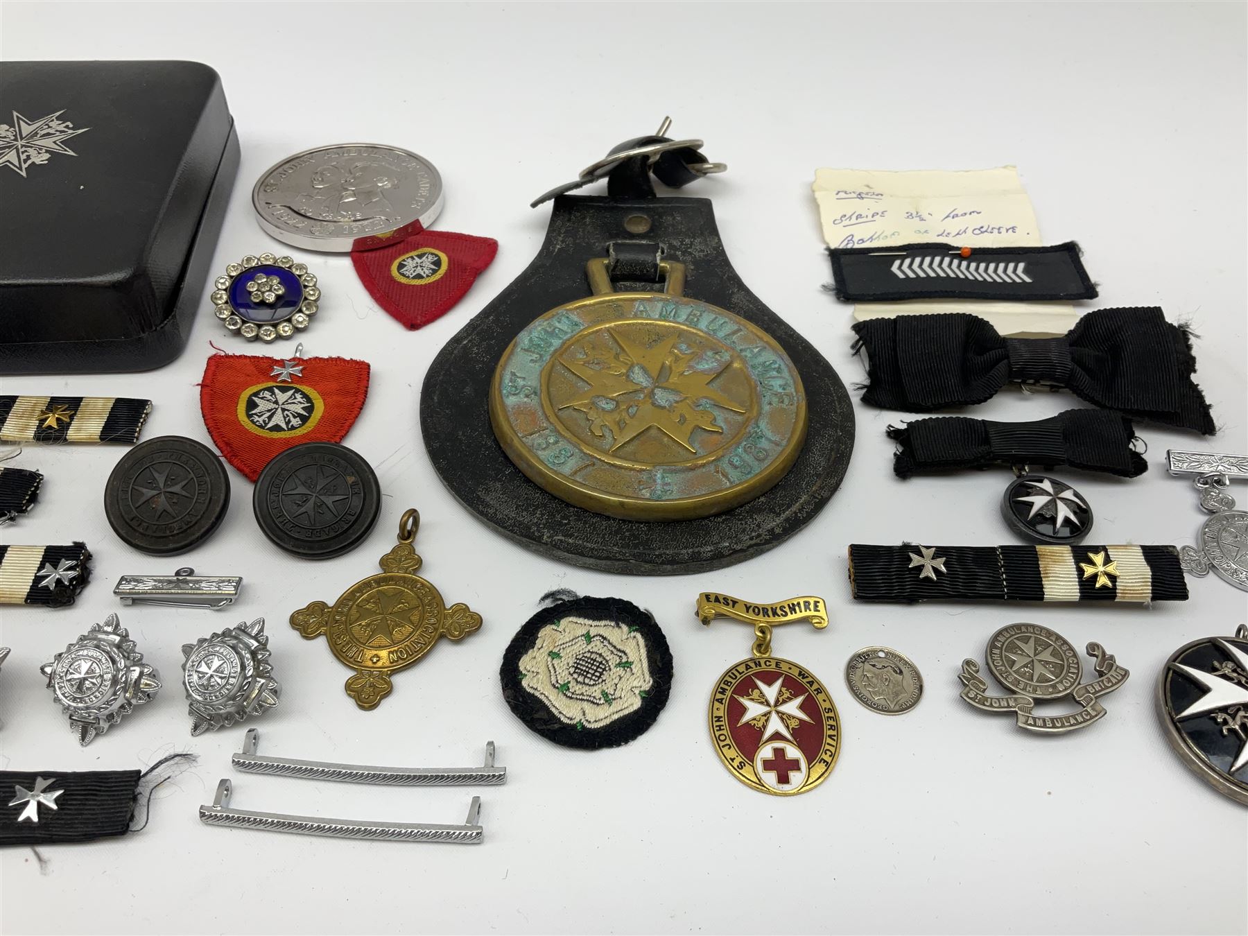 Collection of St John Ambulance enamel, metal and embroidered badges, together with St John Ambulance cadets sixty years medallion and a horse brass  