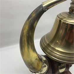 Early 20th century oak and horn dinner bell, the silvered bell suspended from a pair of cow horns, with silver plated mounts and blank shield shaped cartouche, upon square base, H37cm