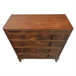 Early 19th century mahogany chest, straight front with canted corners, featuring inlaid detail above two short and three long drawers with flame veneered facias