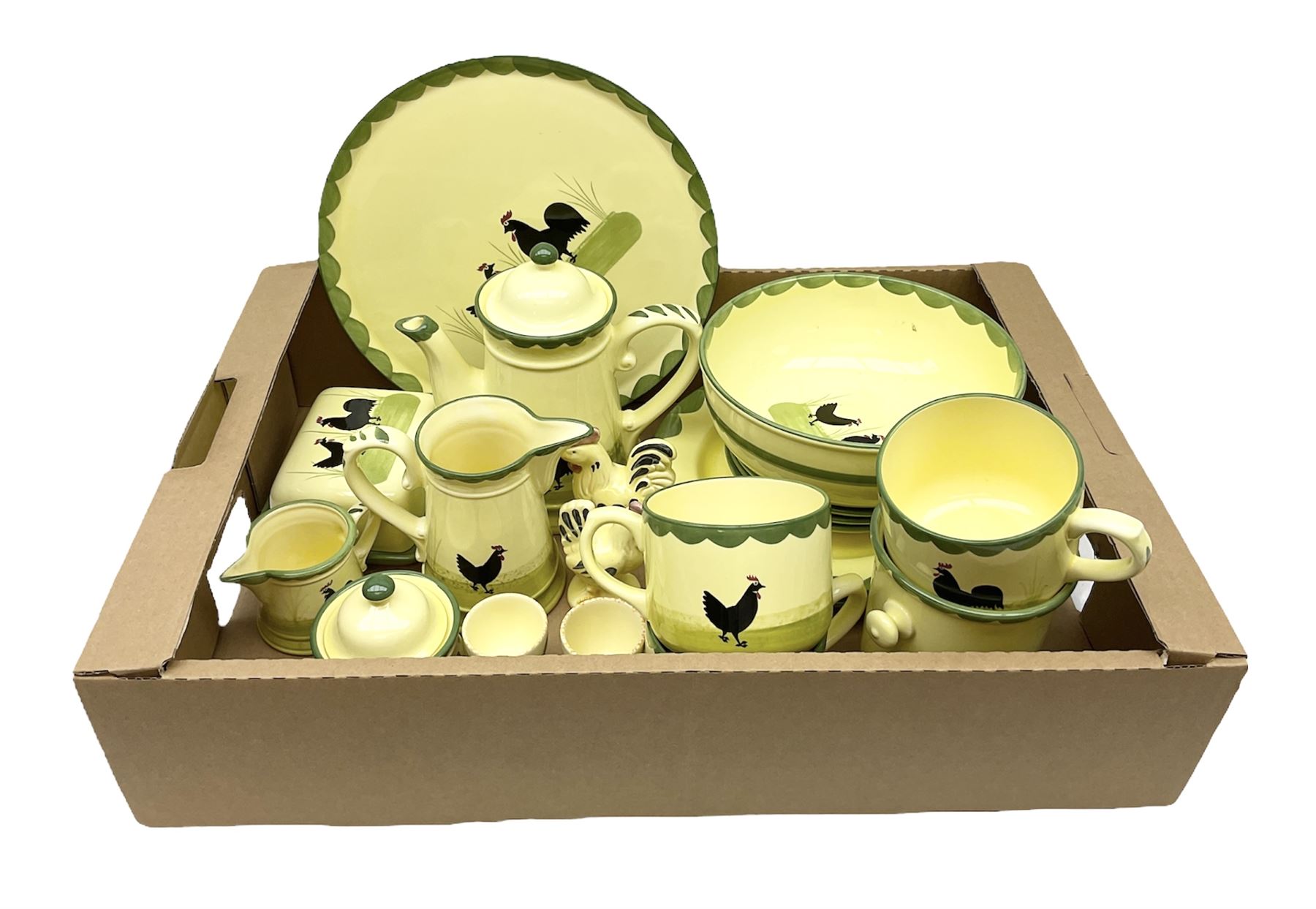 Zeller Fayencerie dinner and tea wares, decorated in cockerels against a yellow ground, with green scalloped border, comprising cake stand, two plates, bowl, three large teacups and saucers, coffee pot, milk jug, cream jug, lidded sugar bowl, pair of cruets modelled as cockerels, butter dish and cover, and utensils pot, and four similar egg cups, in one box 