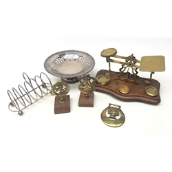  Set of 19th/ early 20th century brass postal scales and matching weights on a shaped mahogany base stamped 'Warranted Accurate'  L25cm, EPNS toast rack, pierced EPNS comport, horse brass and two brass terrets    