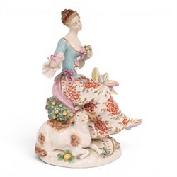Pair of 19th century Samson figures, the gentleman wearing a wide brimmed hat with a dog, the lady with a sheep by her side, both figures seated upon a floral encrusted pillars with gilt scrolling base, H22cm