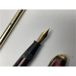 Three fountain pens, to include Conway Stewart 'Dinkie 550' and 'Conway 57' and a Parker 'Slimfold', all with 14ct gold nibs, together two roller ball pens, including a Parker example and a Swarovski Crystal paperweight